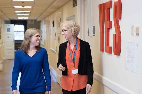 Patient and clinician walk down hall at 3East DBT program