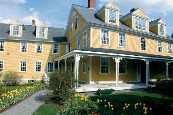 Yellow inn with tulips in front - fernside private inpatient addiction recovery program
