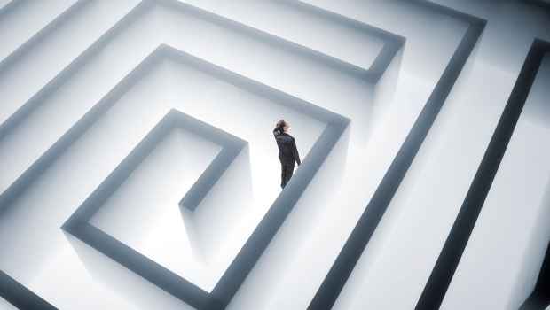 Man scratching his head lost in a maze