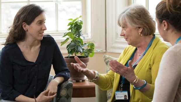 Clinicians talk to patient