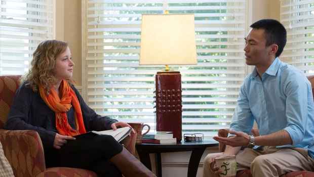Patient and clinician talk in living room
