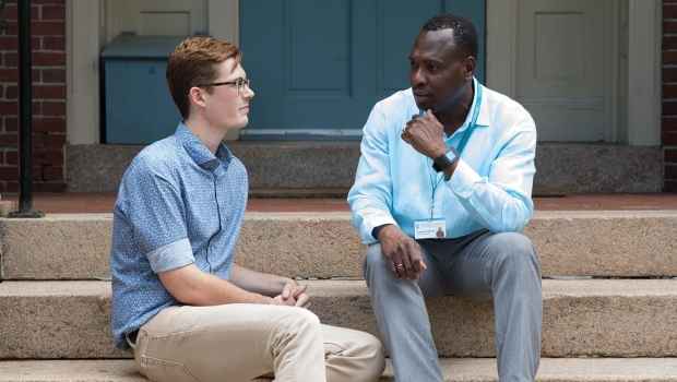 Patient and clinician talk outside on steps