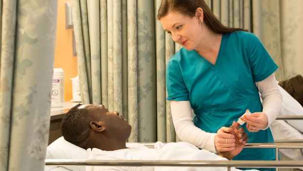 ECT nurse talks to patient in recovery room
