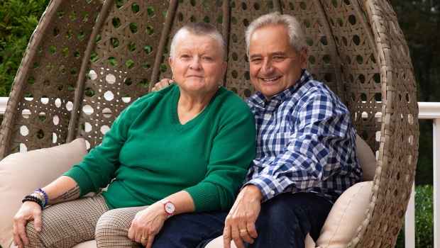 Two people sit in outdoor seating