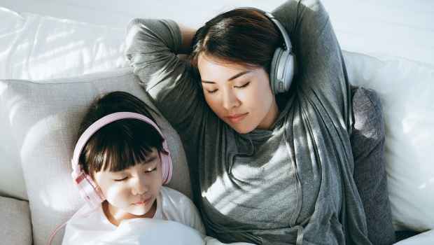 Mom and daughter listening to headphones