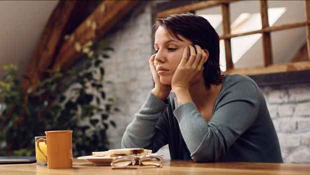 woman at a table looking sad