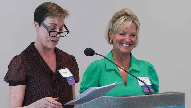 Two women at speaker podium