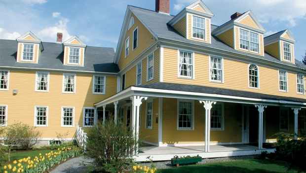 Yellow inn with tulips in front - fernside private inpatient addiction recovery program